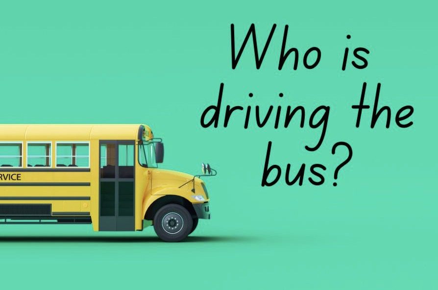A yellow school bus with the text “Who is driving the bus?”