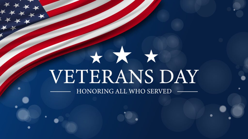 “Veterans Day” text against a blue background with the US flag