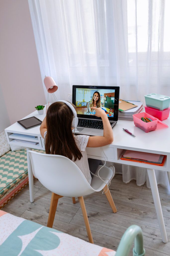 A Little Girl Siting in Front of a Laptop